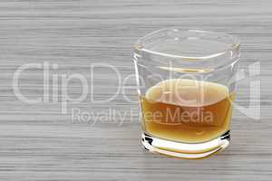 Glass of whisky on wood background