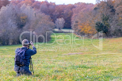 Photographer take pictures  of beech forest near town Olot in Sp