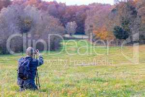 Photographer take pictures  of beech forest near town Olot in Sp