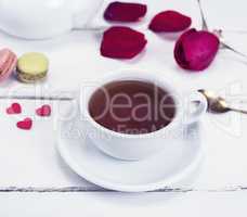 black tea in a white mug with a saucer