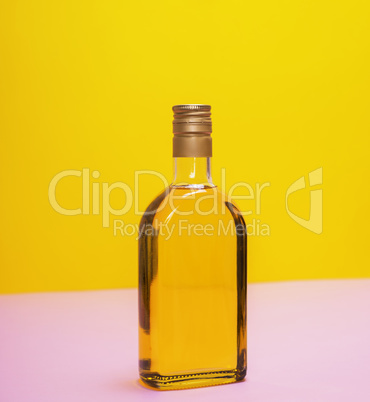 glass bottle with yellow liquid