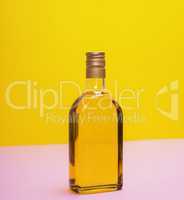 glass bottle with yellow liquid