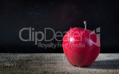 Single apple on a wooden table