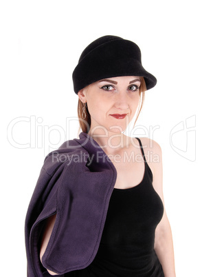 Woman with hat and coat over her shoulder