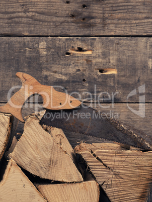 Beech fire wood with rusty saw