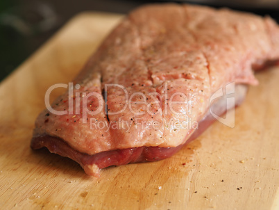 Raw goose breast on a wooden board