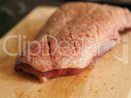 Raw goose breast on a wooden board