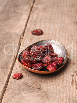 Delicious dried cranberries on wood