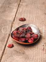 Delicious dried cranberries on wood