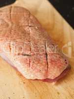 Raw goose breast on a wooden board