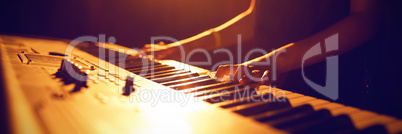 Mid section of female musician playing piano music festival