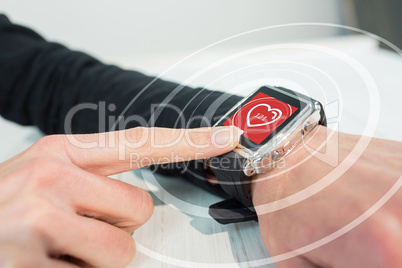 Composite image of businesswoman using a smart watch