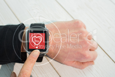 Composite image of businesswoman using a smart watch