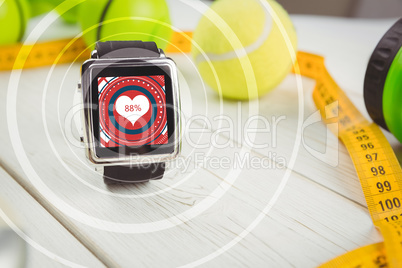 Composite image of smart watch and tape measure with ball