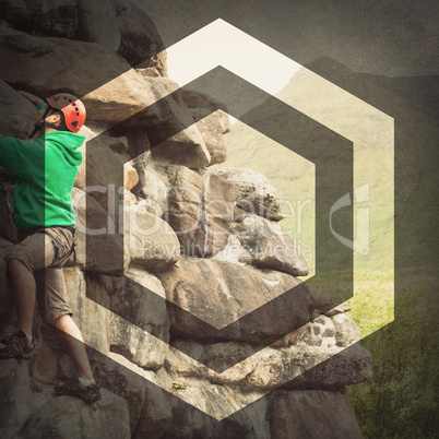 Focused man climbing a large rock face