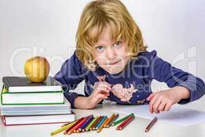 Girl with a stack of books and crayons