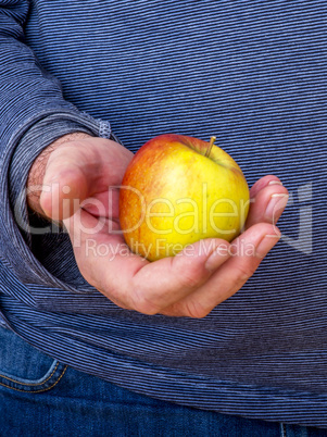 Hand holds apple