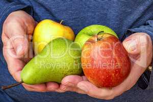 Hand holds apples and pear