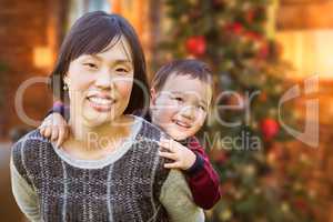 Chinese Mother and Mixed Race Child Inside House In Front of Dec