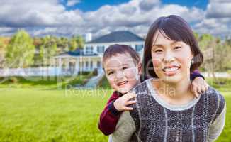 Chinese Mother and Mixed Race Child In The Front Yard of Custom