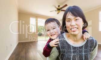 Chinese Mother and Mixed Race Child Inside Empty Room Of New Hou