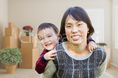 Chinese Mother and Mixed Race Child Inside Empty Room with Movin