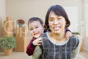 Chinese Mother and Mixed Race Child Inside Empty Room with Movin