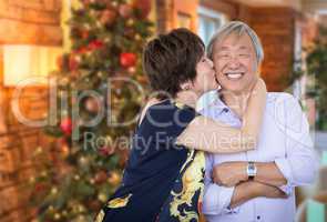 Happy Senior Chinese Couple Kissing In Front of Decorated Christ