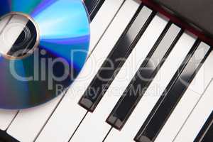CD Laying on Piano Keyboards Abstract