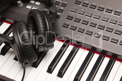 Listening Headphones Laying on Electronic Synthesizer Keyboard