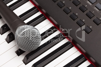 Microphone Laying on Electronic Synthesizer Keyboard Abstract