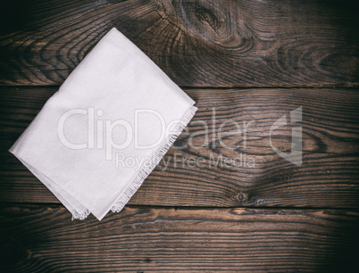 kitchen napkin on a brown wooden background