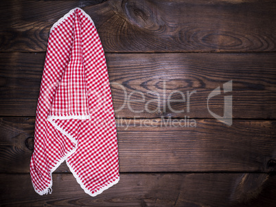 textile kitchen napkin hanging on a wooden wall