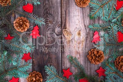 gray wood background with green spruce branches