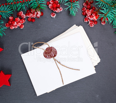 empty white paper covert sealed and green spruce branches