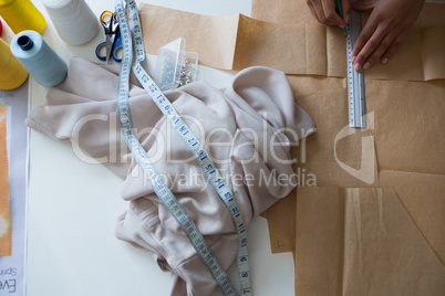 Fashion designer marking on brown paper