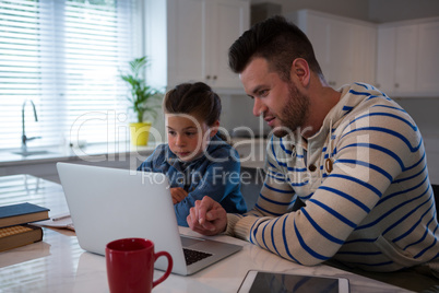 Father assisting daughter in her studies