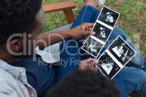 Couple looking at sonography in park