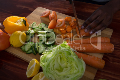 Woman chopping vegetables in kitchen