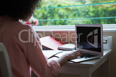 Woman using laptop at home