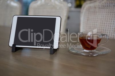 Digital tablet and lemon tea on dining table