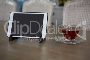 Digital tablet and lemon tea on dining table
