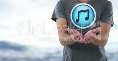Music note icon and hands palm open in landscape