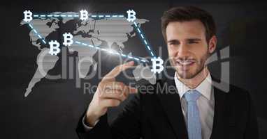 Businessman touching bitcoin graphic icons on world map connecting
