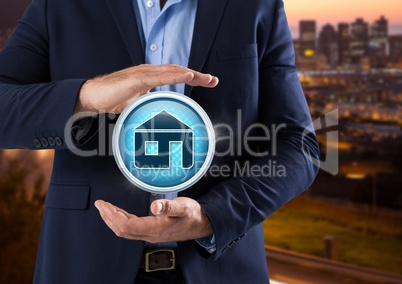 Home icon and Businessman with hands palm open in city at evening