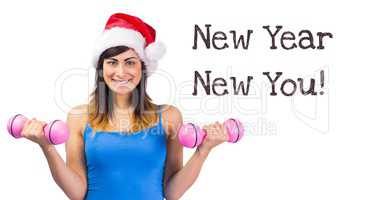 New year New you text and fit woman lifting weights in Santa hat