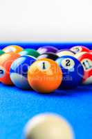 Billiard balls in a blue pool table.