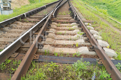 Rusty old rails in the city in nature.