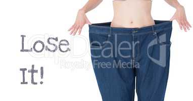 Lose it text and fit woman's waist in oversized trousers