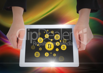 Bitcoin icons and hands holding tablet